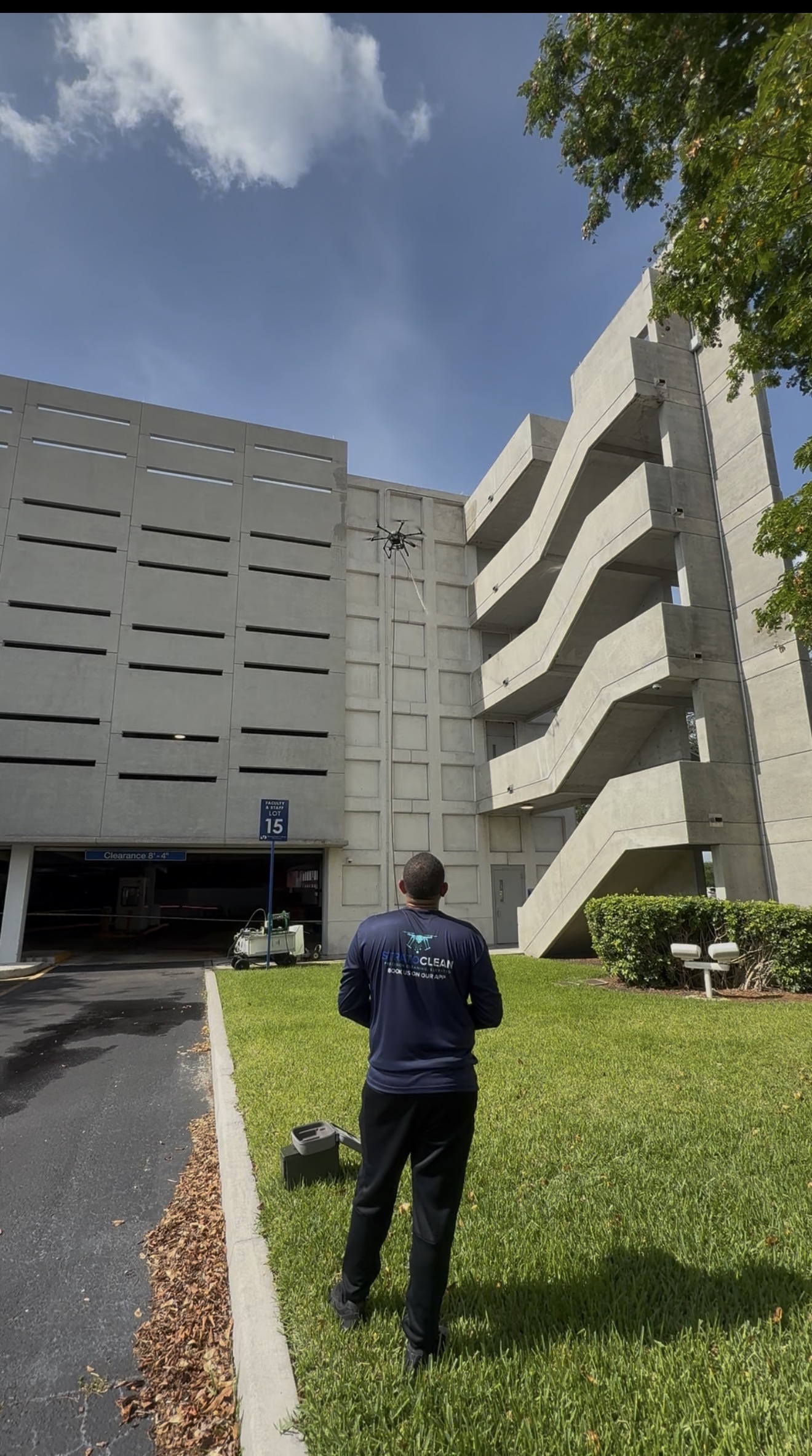 Drone soft wash on the elevated concrete wall of a Miami Dade College parking garage